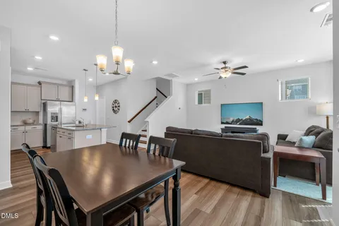 a view of a dining room with furniture and a kitchen