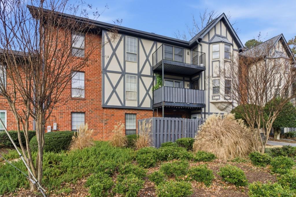 a front view of a house with large windows and a yard