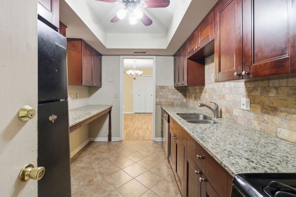 6851 Roswell Road, Unit B15 Sandy Springs, GA 30328 - Photo 11 of 30 a kitchen with stainless steel appliances granite countertop a sink and cabinets