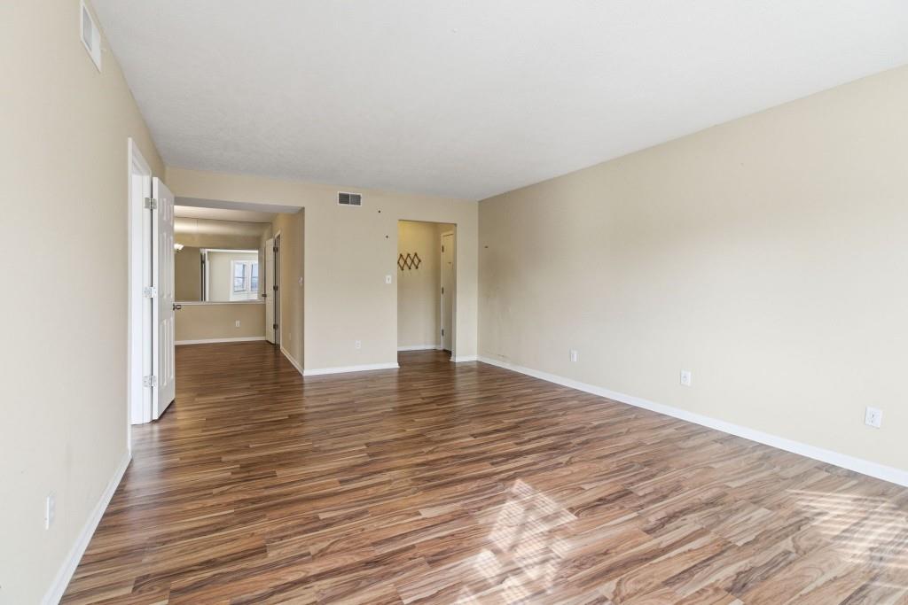 6851 Roswell Road, Unit B15 Sandy Springs, GA 30328 - Photo 13 of 30 a view of an empty room and wooden floor