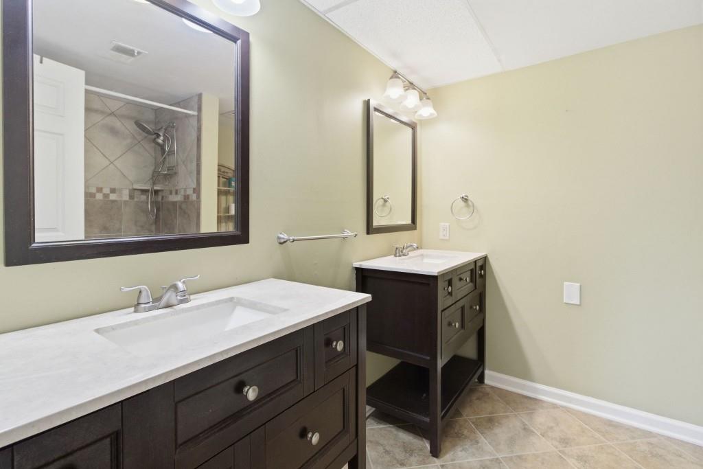 6851 Roswell Road, Unit B15 Sandy Springs, GA 30328 - Photo 19 of 30 a bathroom with a sink vanity and a mirror