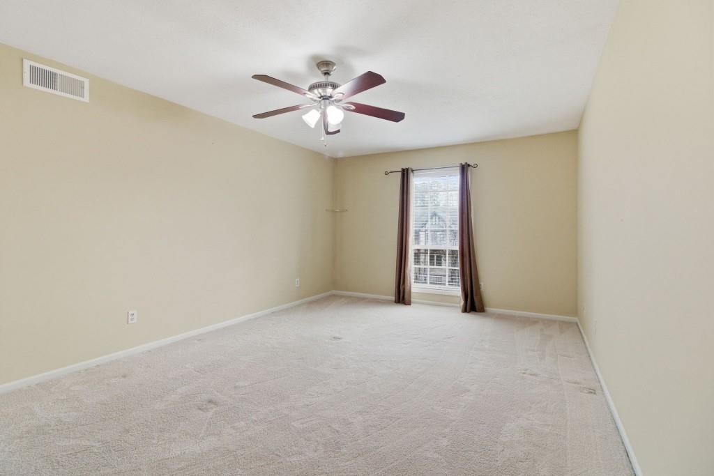 6851 Roswell Road, Unit B15 Sandy Springs, GA 30328 - Photo 22 of 30 an empty room with windows and fan