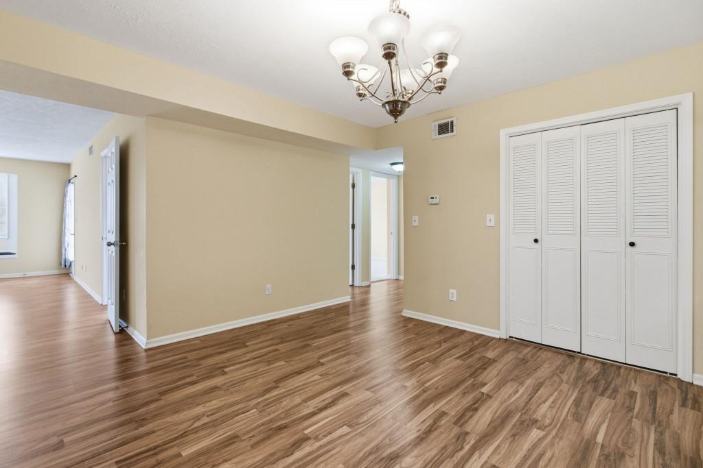 6851 Roswell Road, Unit B15 Sandy Springs, GA 30328 - Photo 8 of 30 wooden floor in an empty room with a window