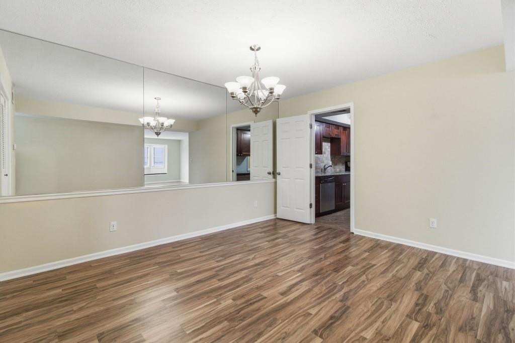 6851 Roswell Road, Unit B15 Sandy Springs, GA 30328 - Photo 9 of 30 a view of a kitchen with wooden floor and a kitchen