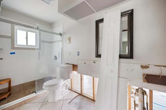 a bathroom with a toilet sink and a mirror