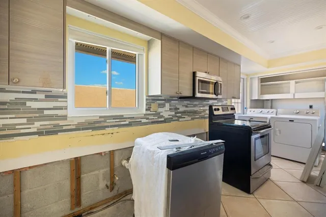 a kitchen with a stove a sink and a microwave