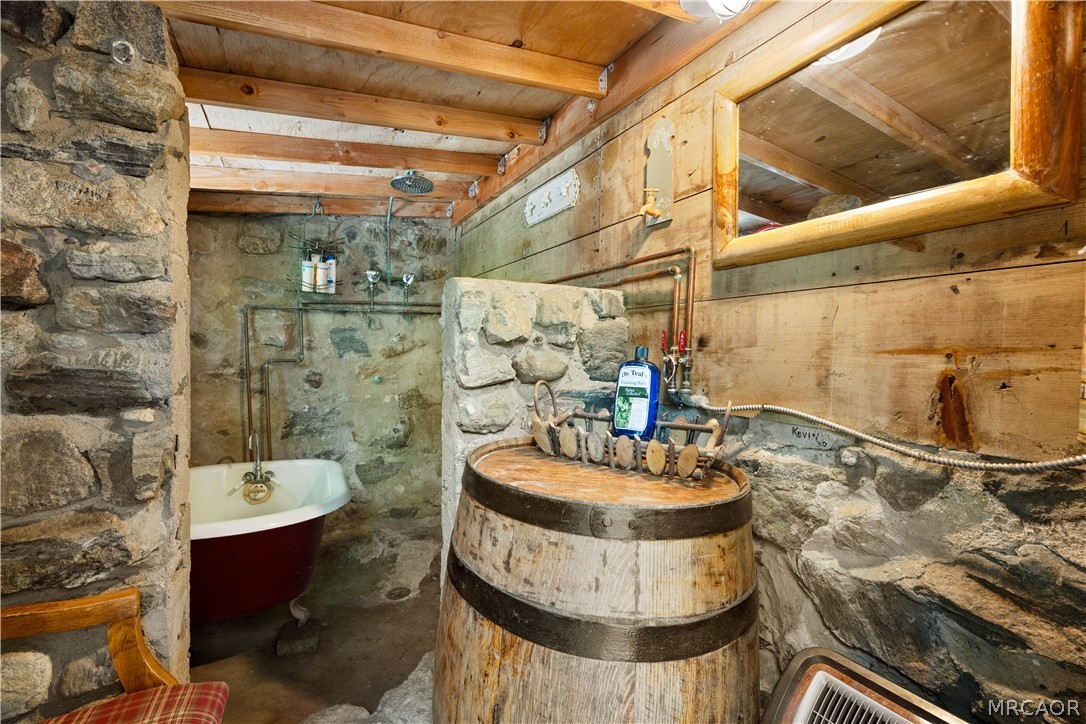 70 Barton Flats Road Angelus Oaks, CA 92305 - Photo 30 of 44 Unique bathroom located at the back of the cabin. A claw foot tub and a rain shower head make bathing a unique experience.