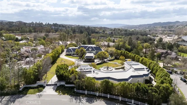 an aerial view of a house with a yard basket ball court and outdoor seating