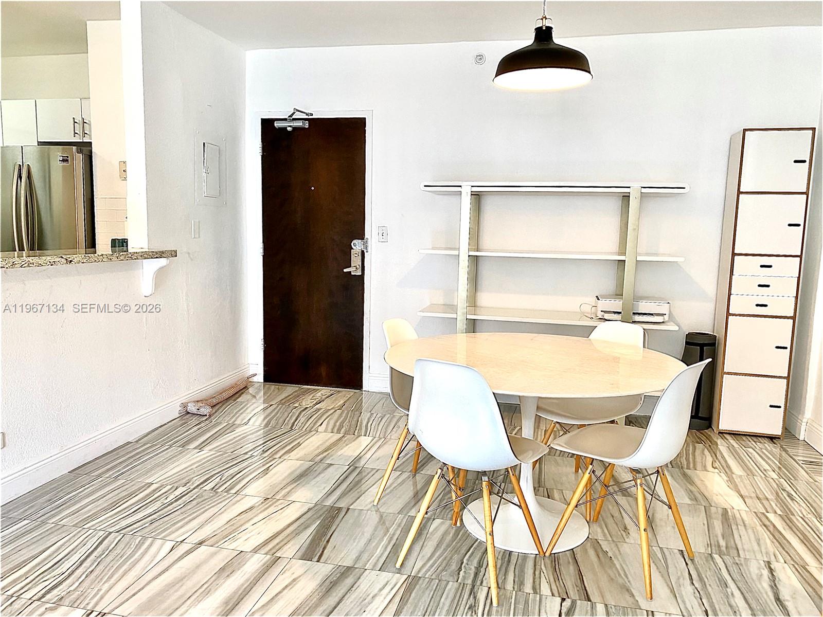 1500 Bay Road, Unit 862S Miami Beach, FL 33139 - Photo 4 of 30 Kitchen snackbar opens to the dining area keeping the chef engaged with guests.