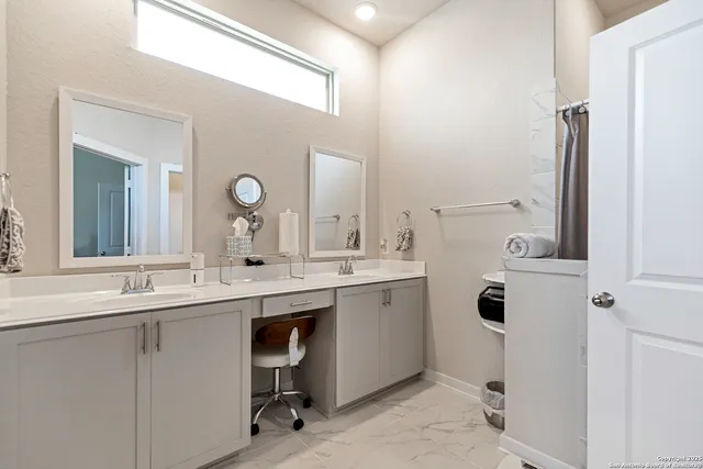 a bathroom with a double vanity sink mirror and