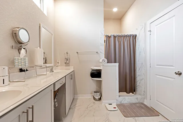 a bathroom with a double vanity sink and a mirror