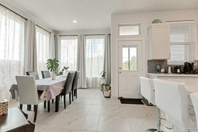 a view of a dining room with furniture and windows