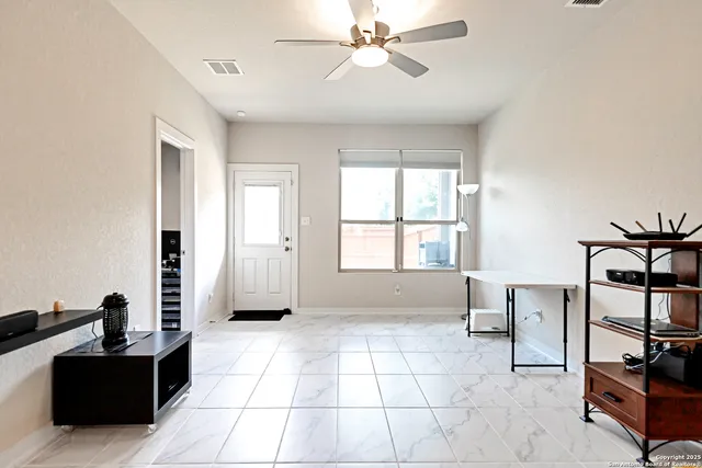 a view of a livingroom with furniture and windows