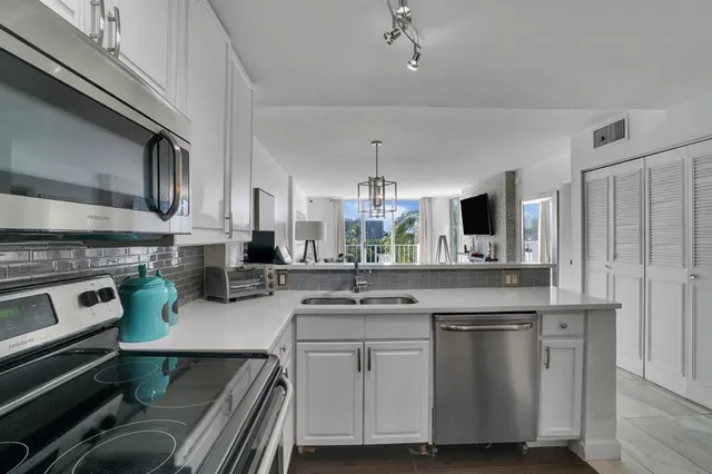 a kitchen with a sink stove and cabinets