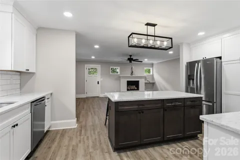 a kitchen with stainless steel appliances a refrigerator and a stove top oven