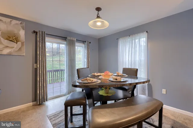 a dining room with furniture and window