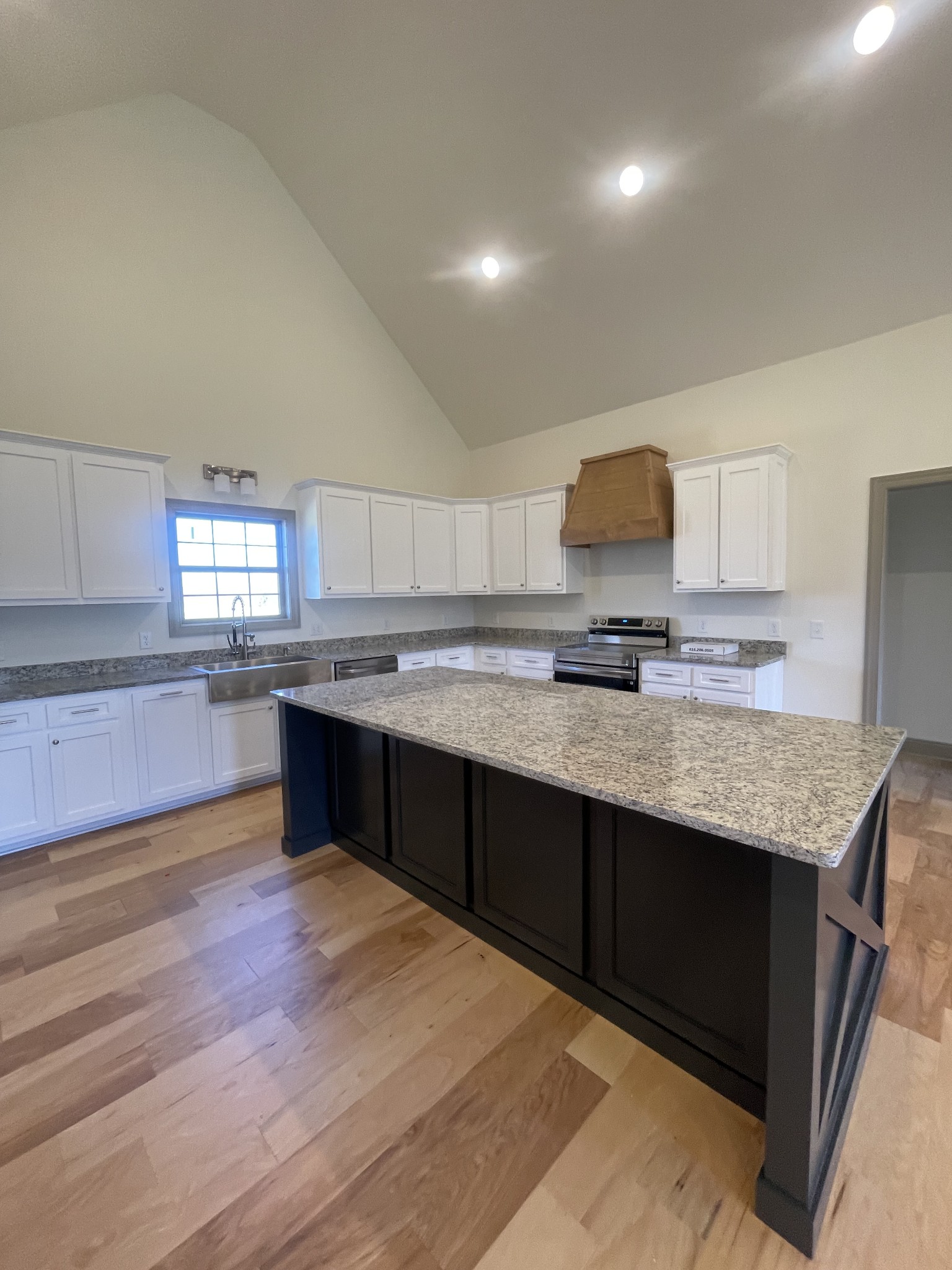 5151 Galen Road Lafayette, TN 37083 - Photo 8 of 37 a kitchen with granite countertop wooden cabinets and white appliances