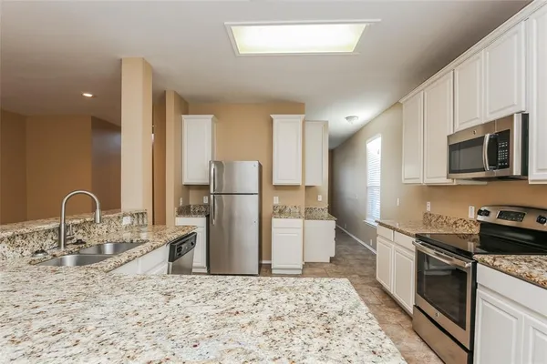 an empty room with windows and ceiling fan