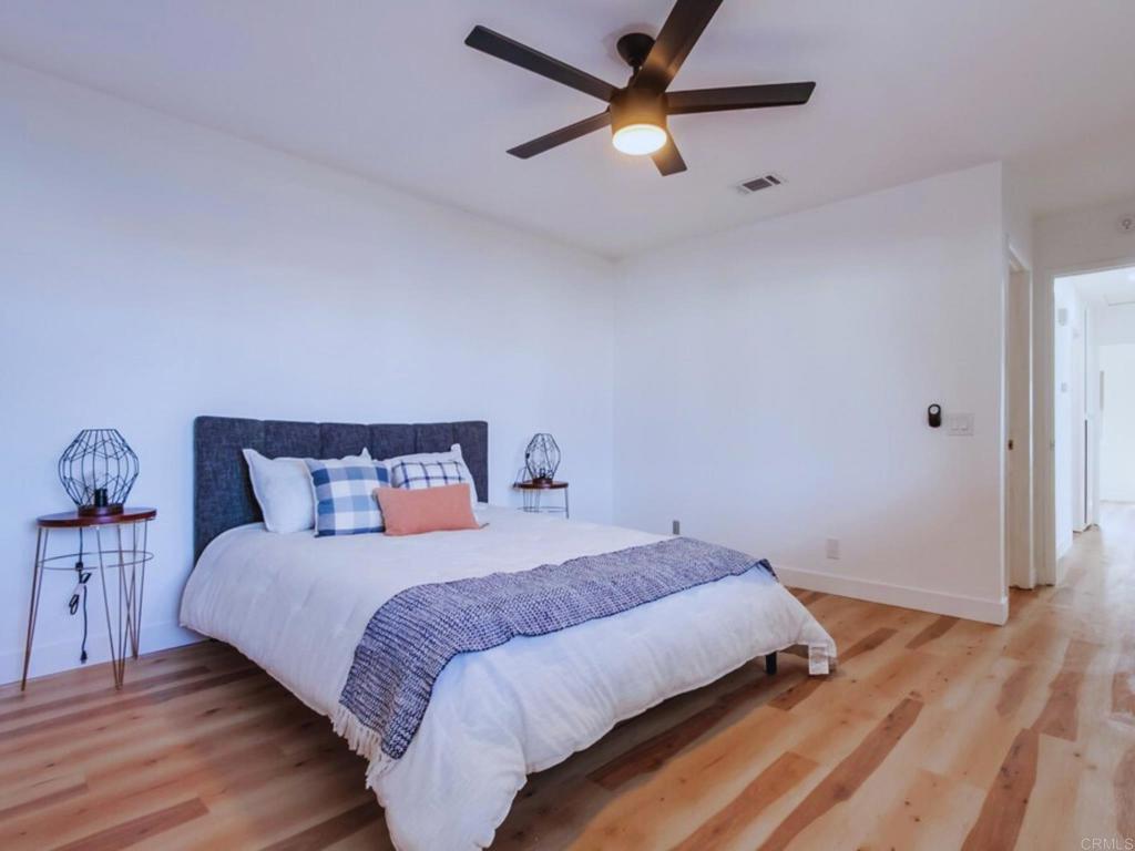 1025 Plover Way Oceanside, CA 92057 - Photo 13 of 36 a bedroom with a bed and a ceiling fan