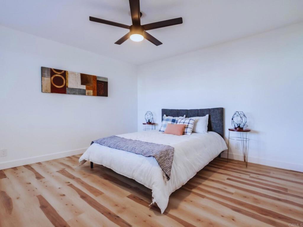 1025 Plover Way Oceanside, CA 92057 - Photo 14 of 36 a bedroom with bed and wooden floor