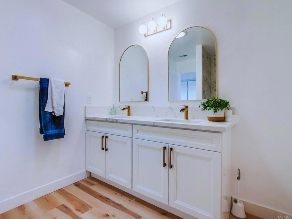1025 Plover Way Oceanside, CA 92057 - Photo 18 of 36 a bathroom with a double vanity sink and a mirror
