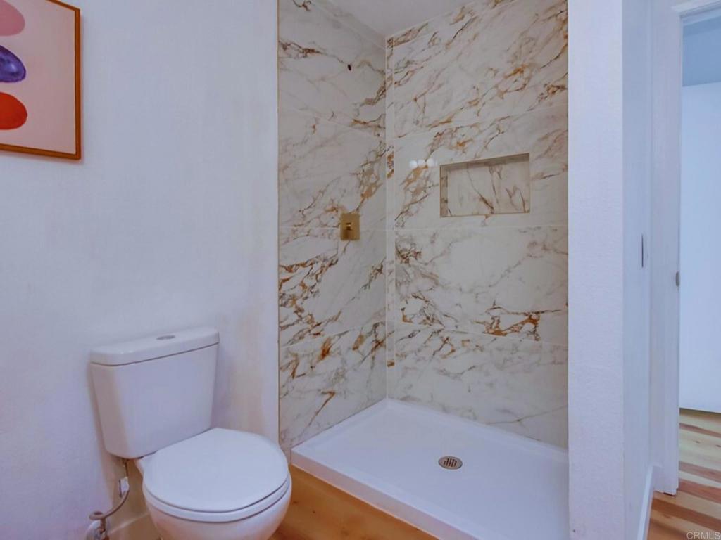 1025 Plover Way Oceanside, CA 92057 - Photo 19 of 36 a white toilet sitting next to a bath tub and a shower