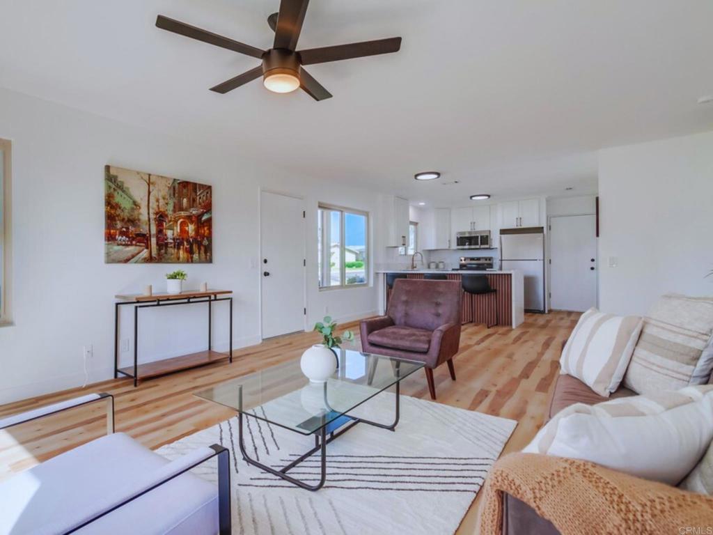 1025 Plover Way Oceanside, CA 92057 - Photo 2 of 36 a living room with furniture and kitchen view