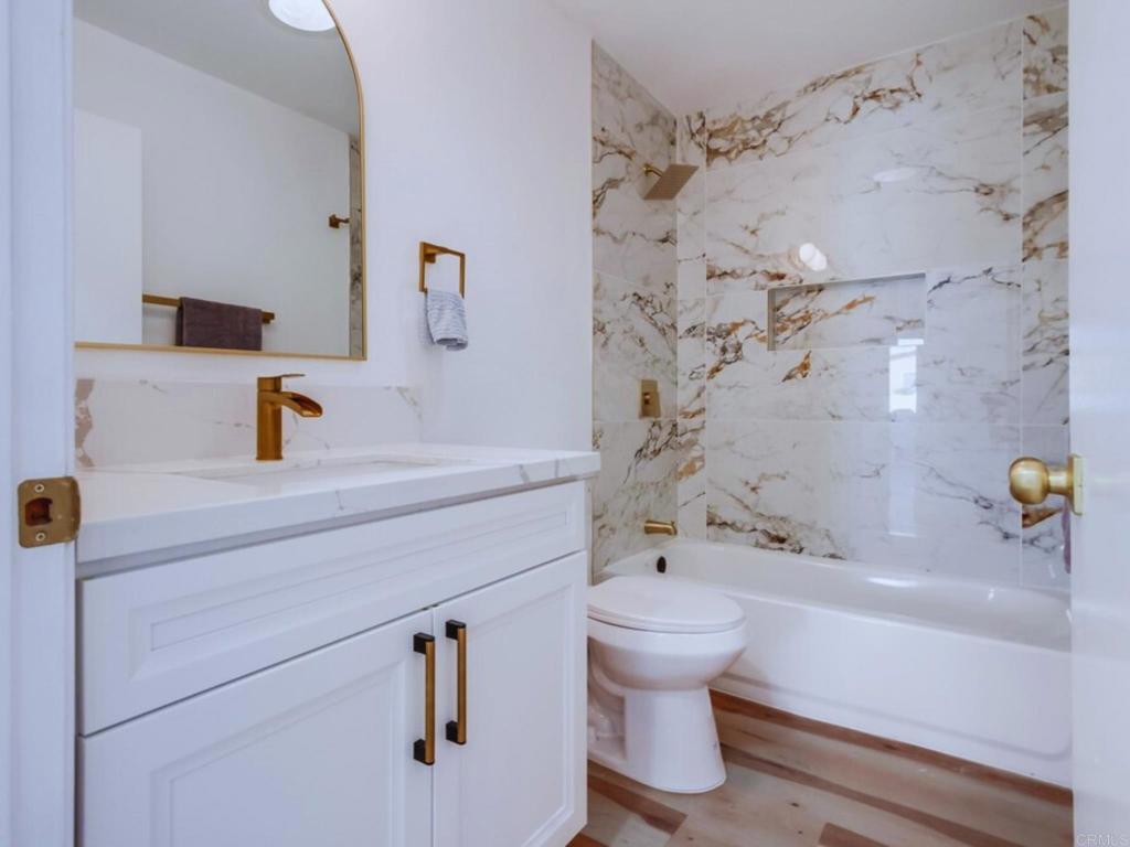 1025 Plover Way Oceanside, CA 92057 - Photo 25 of 36 a bathroom with a sink and a toilet