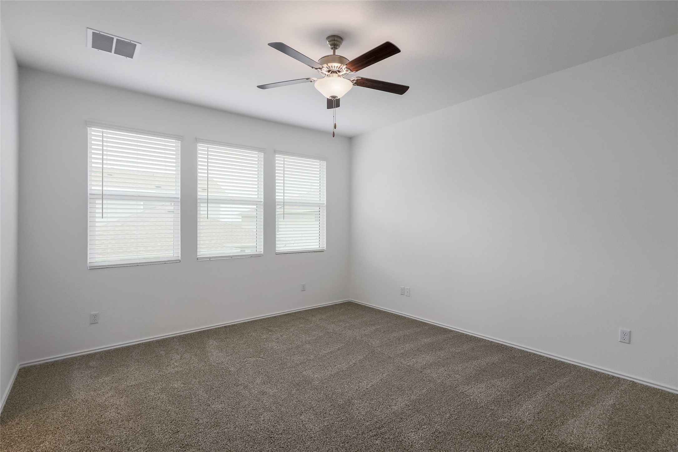 818 Affazia Lane Georgetown, TX 78628 - Photo 13 of 27 an empty room with ceiling fan and windows