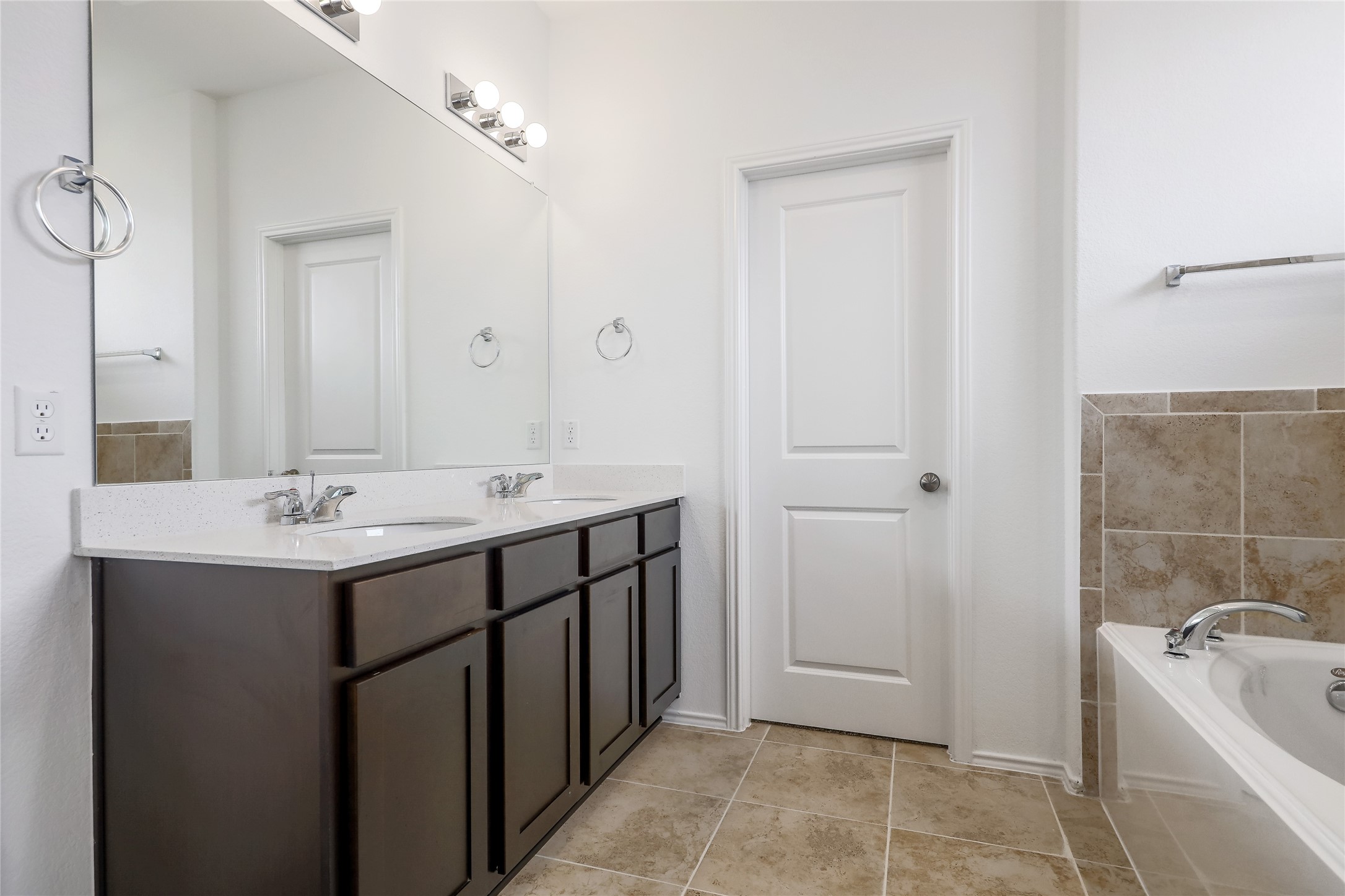 818 Affazia Lane Georgetown, TX 78628 - Photo 15 of 27 a bathroom with a tub sink and mirror
