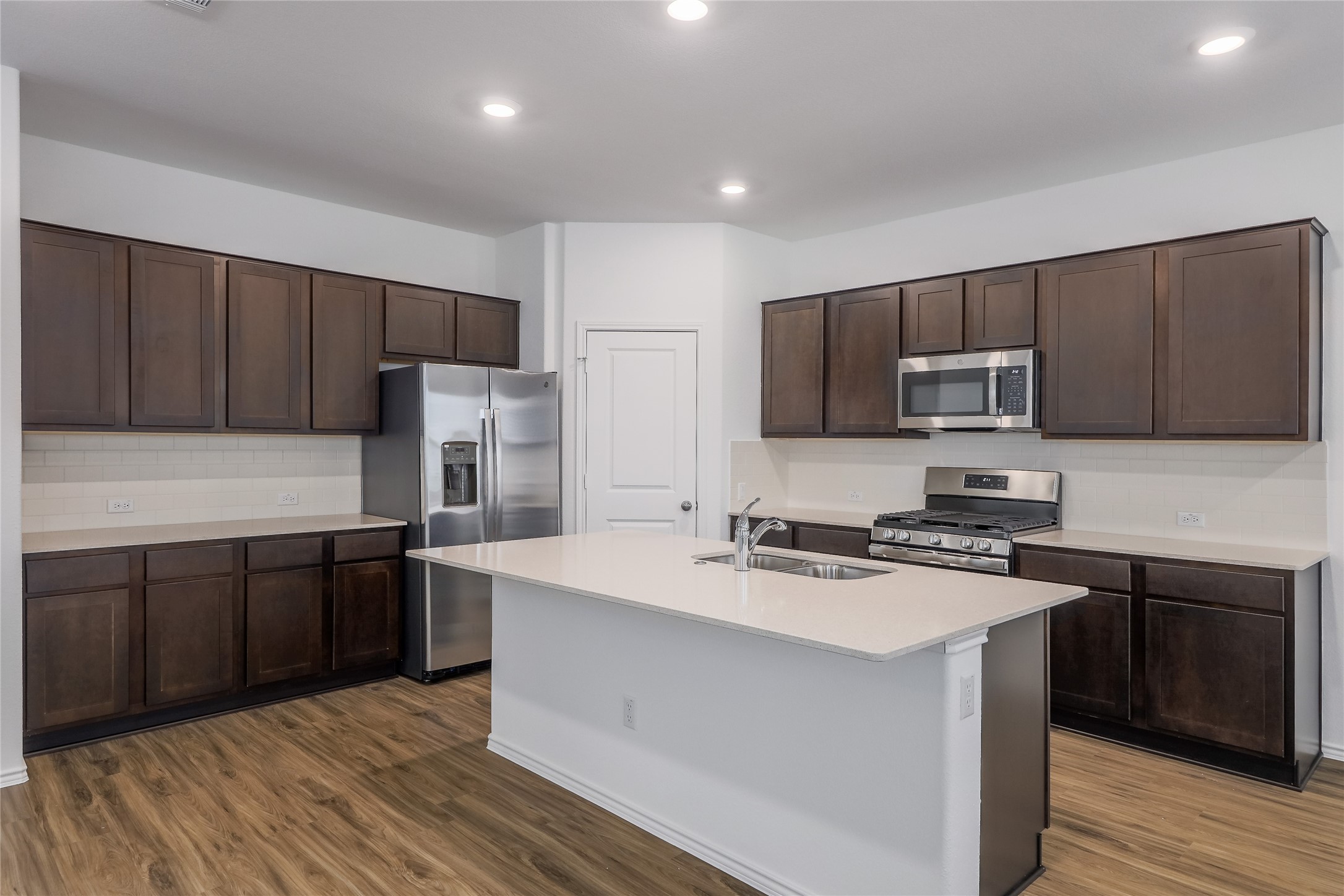 818 Affazia Lane Georgetown, TX 78628 - Photo 8 of 27 a kitchen with wooden cabinets and stainless steel appliances