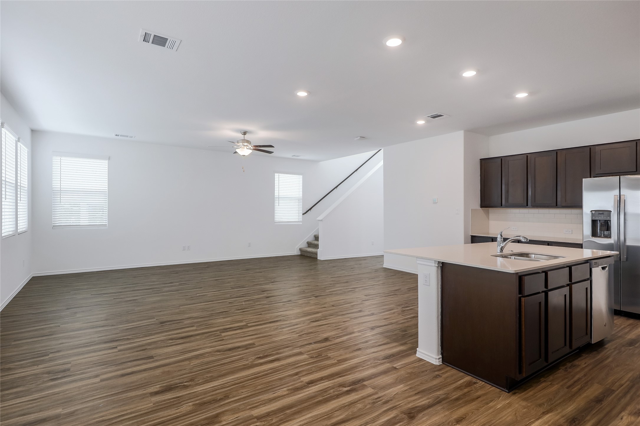 818 Affazia Lane Georgetown, TX 78628 - Photo 9 of 27 a kitchen with stainless steel appliances a stove and wooden floor