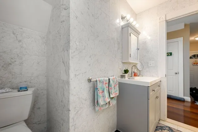 a bathroom with a bathtub sink mirror and toilet