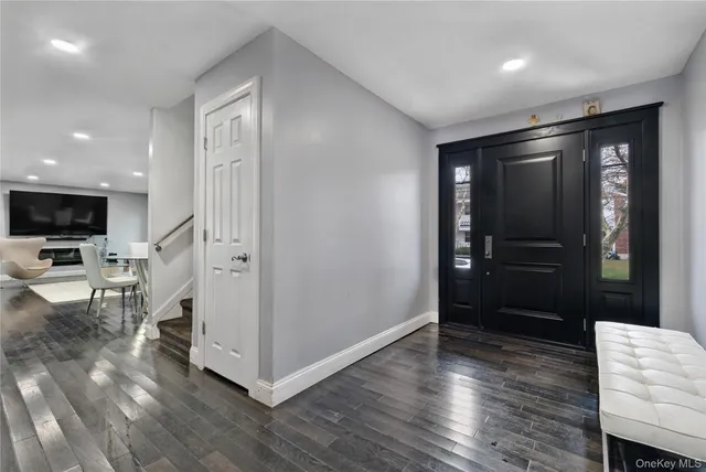 a view of a livingroom with wooden floor and a flat screen tv