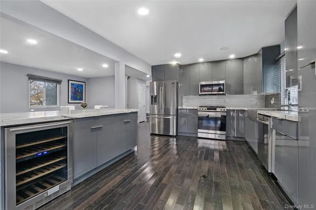 a kitchen with a sink stainless steel appliances and cabinets