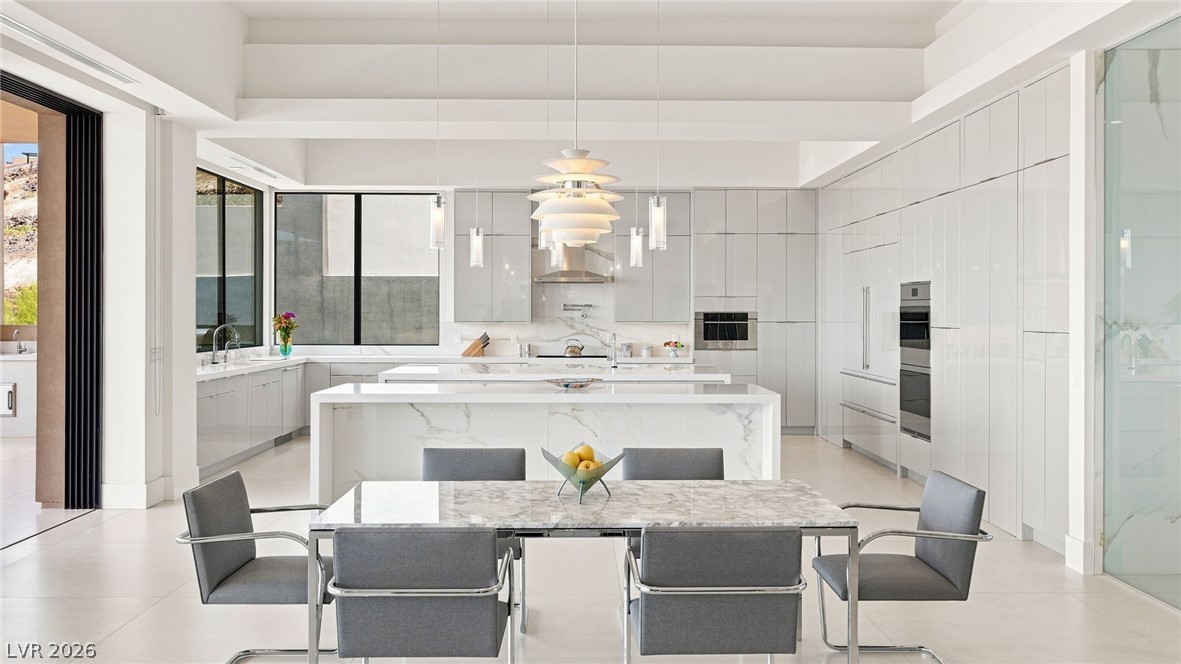 677 Overlook Rim Drive Henderson, NV 89012 - Photo 20 of 97 Soaring ceilings and seamless floor-to-ceiling cabinetry define this open and airy contemporary kitchen.