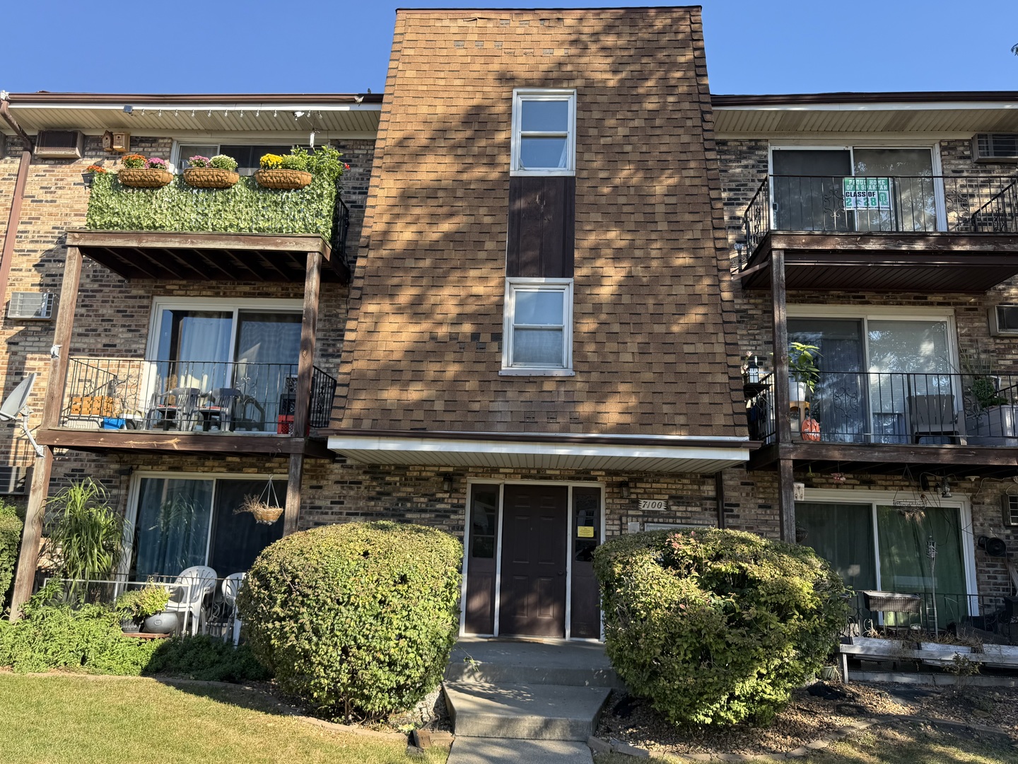 a front view of a building with garden