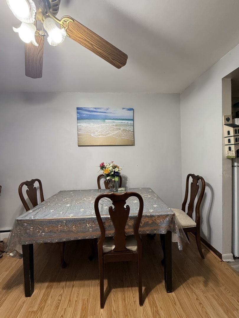 7100 99th Street, Unit 204 Chicago Ridge, IL 60415 - Photo 3 of 9 a view of a dining room with furniture and wooden floor