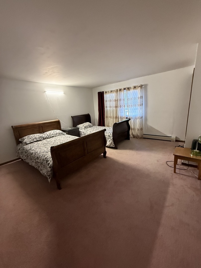 7100 99th Street, Unit 204 Chicago Ridge, IL 60415 - Photo 9 of 9 a bedroom with a bed and a couch