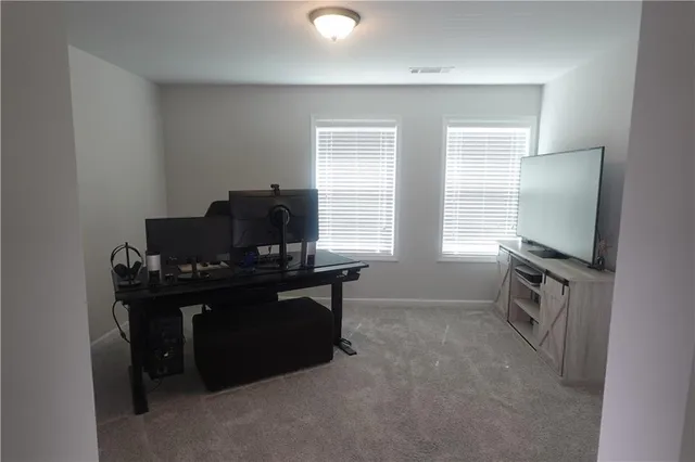 a view of workspace with furniture and window