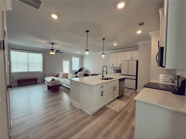 a large white kitchen with lots of counter space