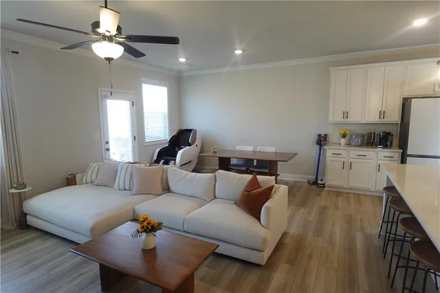 a living room with furniture and a chandelier