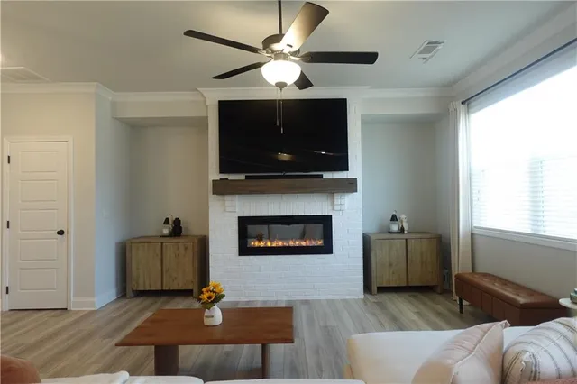 a living room with furniture a flat screen tv and a fireplace