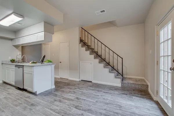 a view of entryway and hall with wooden floor