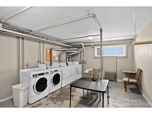a utility room with dryer washer and a sink