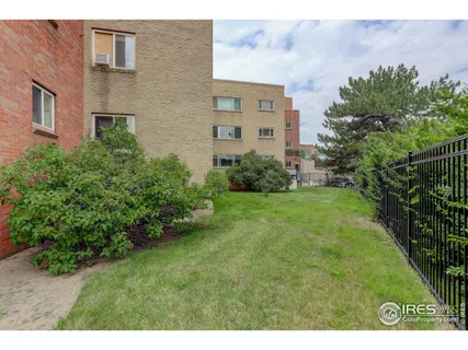 a view of a brick building next to a yard