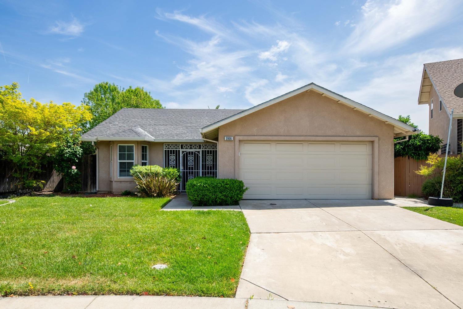 3906 Amelia Drive Stockton, CA 95204 - Photo 1 of 1 a front view of a house with a yard and garage