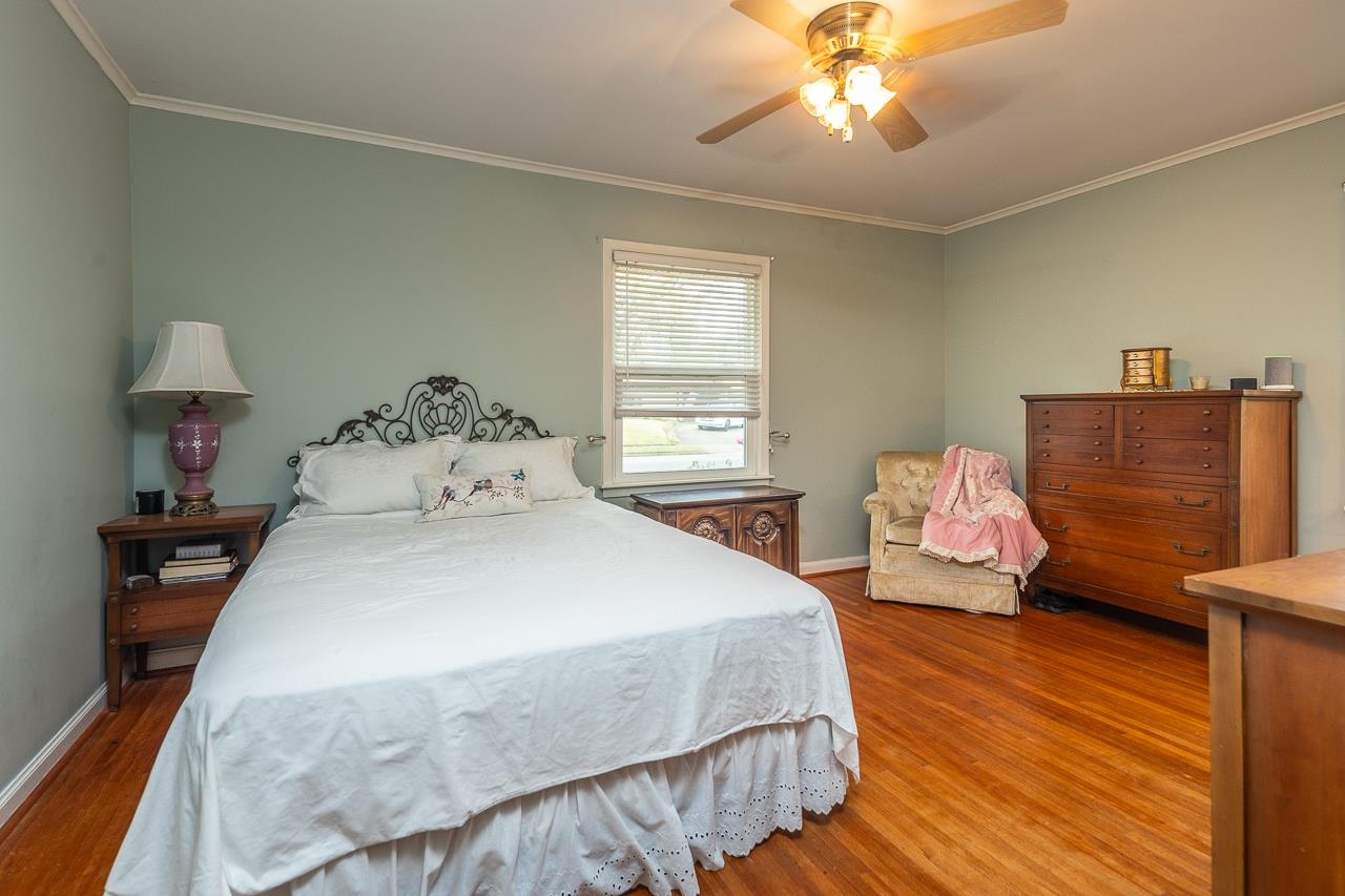 5130 Mason Road Memphis, TN 38117 - Photo 13 of 26 a bedroom with a bed and wooden floor