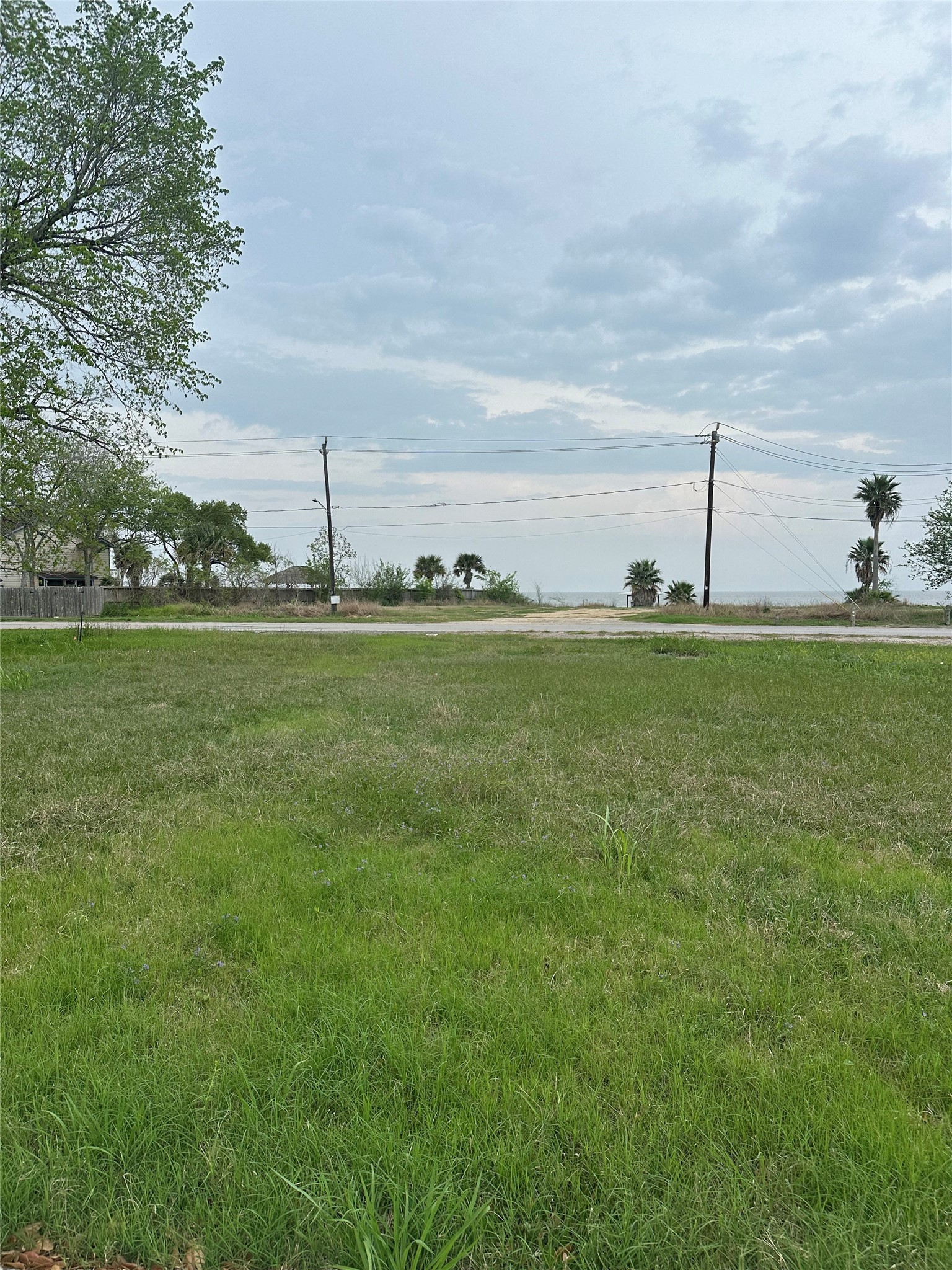 1 Jackson Avenue Bacliff, TX 77518 - Photo 4 of 6 a view of a green field with an trees