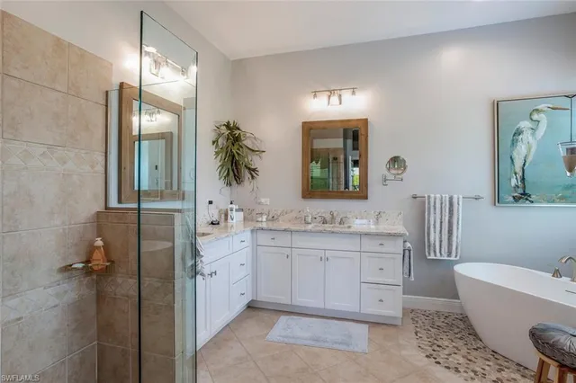 a bedroom with a bed and a couch next to a window